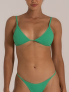 Front view of a woman wearing a green triangle bikini set with a subtle textured pattern, adjustable shoulder straps, and a minimal coverage bottom for a sleek, modern swimwear look.