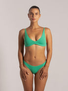  Front view of a model wearing green textured V-neck bikini set, ideal for beachwear or swim days