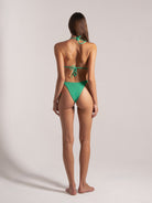 Back view of green triangle bikini set with textured fabric and cheeky cut bottom.