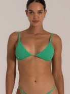 Front close-up of green textured triangle bikini top with thin adjustable straps.