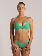 Front view of green triangle bikini top in textured fabric with deep scoop design