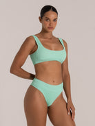 Front view of green bikini top with wide straps and supportive fit