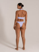 Back view of a lilac textured halter neck bikini with cheeky cut bottom