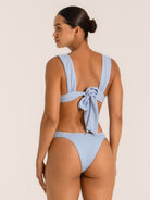 Side angle of textured baby blue bikini bottom showing flattering high waist fit.