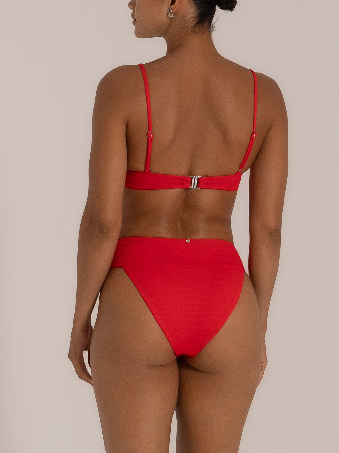 Back view of red high waist bikini bottom with wide waistband and clasp strap top