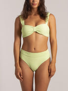 Full frontal view of high-waisted lime green bikini bottom with sculpting fit.