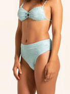 Ice blue high-waisted bikini bottom in modern textured swimwear style.