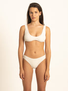 Straight-on front view of the Ivory ribbed scoop bikini top and matching bottoms, demonstrating the premium textured fabric and supportive fit.