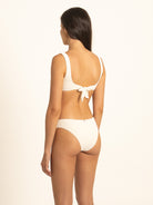 Back 45-degree view illustrating the comfortable, dig-free back styling of the Ivory ribbed bikini set, perfect for mix and match bikini separates.