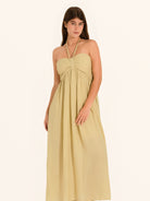 Front view of khaki halter maxi dress with strapless neckline and flowy fit