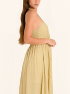 Side profile of khaki halter maxi dress with relaxed silhouette