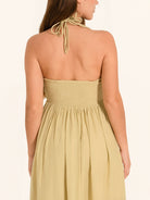 Back view of khaki maxi dress with halter tie straps and loose skirt