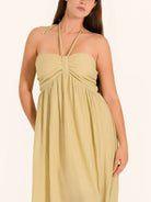 Closeup front of khaki maxi dress with halter tie neckline and gathered bodice