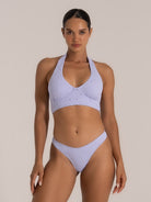 Full body view of lavender embroidered halter bikini top with supportive wide band