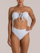Front view of a woman in a light blue bandeau bikini top with center drawstring and matching high-waist bottoms.