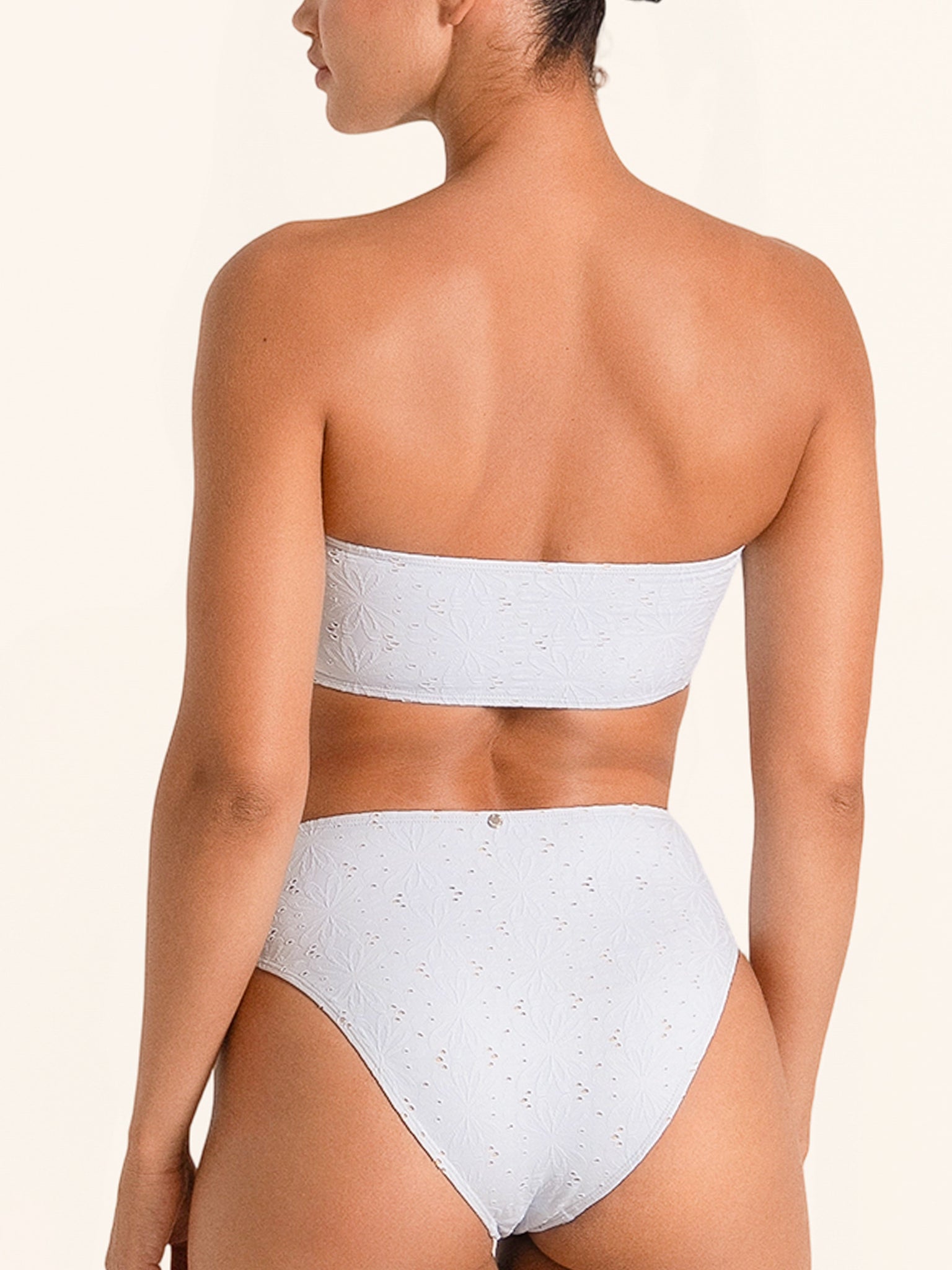 Light blue strapless bikini top with cutout and adjustable tie front.