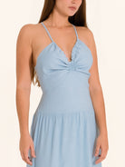 Closeup front of light blue maxi dress with knotted bust detail and slim straps