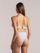 Back view of light blue ribbed bikini top with adjustable straps and clasp closure