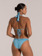 Back view of light blue shimmer triangle bikini top with halter neck and adjustable tie