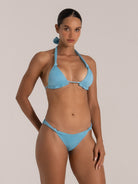 Front close-up of sparkly light blue bikini top with halter tie and minimal coverage design