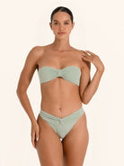 Light green bandeau bikini top in strapless style with soft textured fabric.
