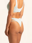 Back view of light green bikini bottom with cheeky coverage and modern cut.