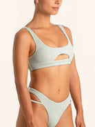 Back view of light green bikini top with scoop cut and wide straps.