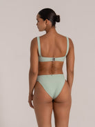 Ribbed light green bikini bottom featuring sculpting waistband and soft texture