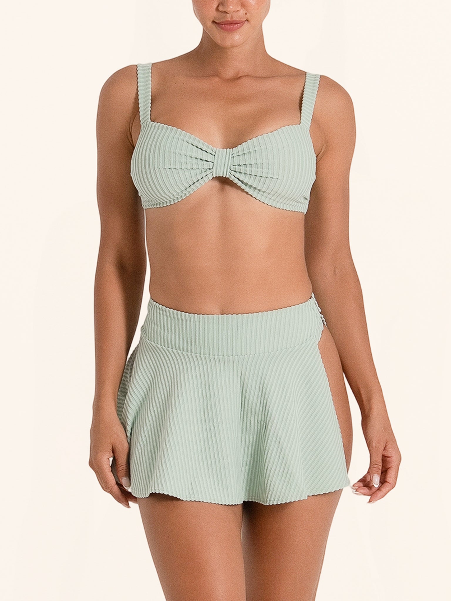 Light green swim skirt bikini bottom with ribbed texture.