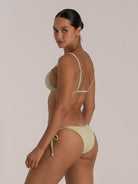 Back view of light green triangle bikini top with textured ribbed fabric and adjustable straps