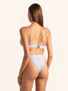 Back angle of light grey ribbed bikini bottom with minimal coverage and ribbed detail.