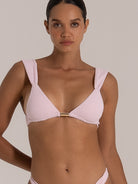 Close-up front view of light pink triangle bikini top with gold center ring detail