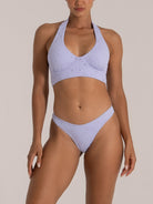 Close-up front view of floral embroidered lavender bikini with wide halter neck and mid-rise bottom.