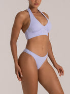 Light purple floral textured bikini set featuring halter neckline and sculpted bralette, front-side view.