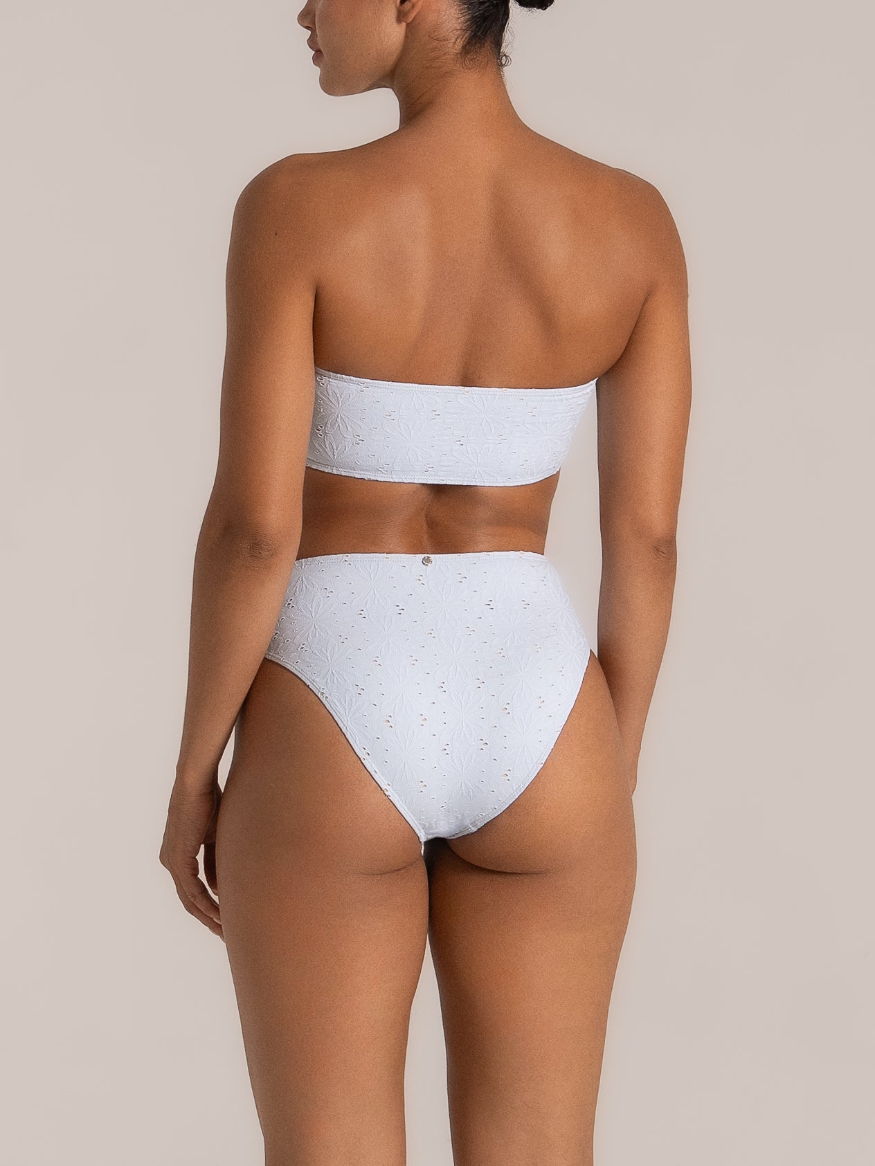 Back view of light purple textured bikini bottom with cheeky cut and soft stretch fit