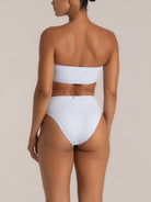 Back view of light purple textured bikini bottom with cheeky cut and soft stretch fit