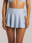 Light blue pleated swim skirt with high waist and cut-out detail at front.