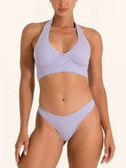 Lilac bikini bottom with cutout detail and cheeky coverage.