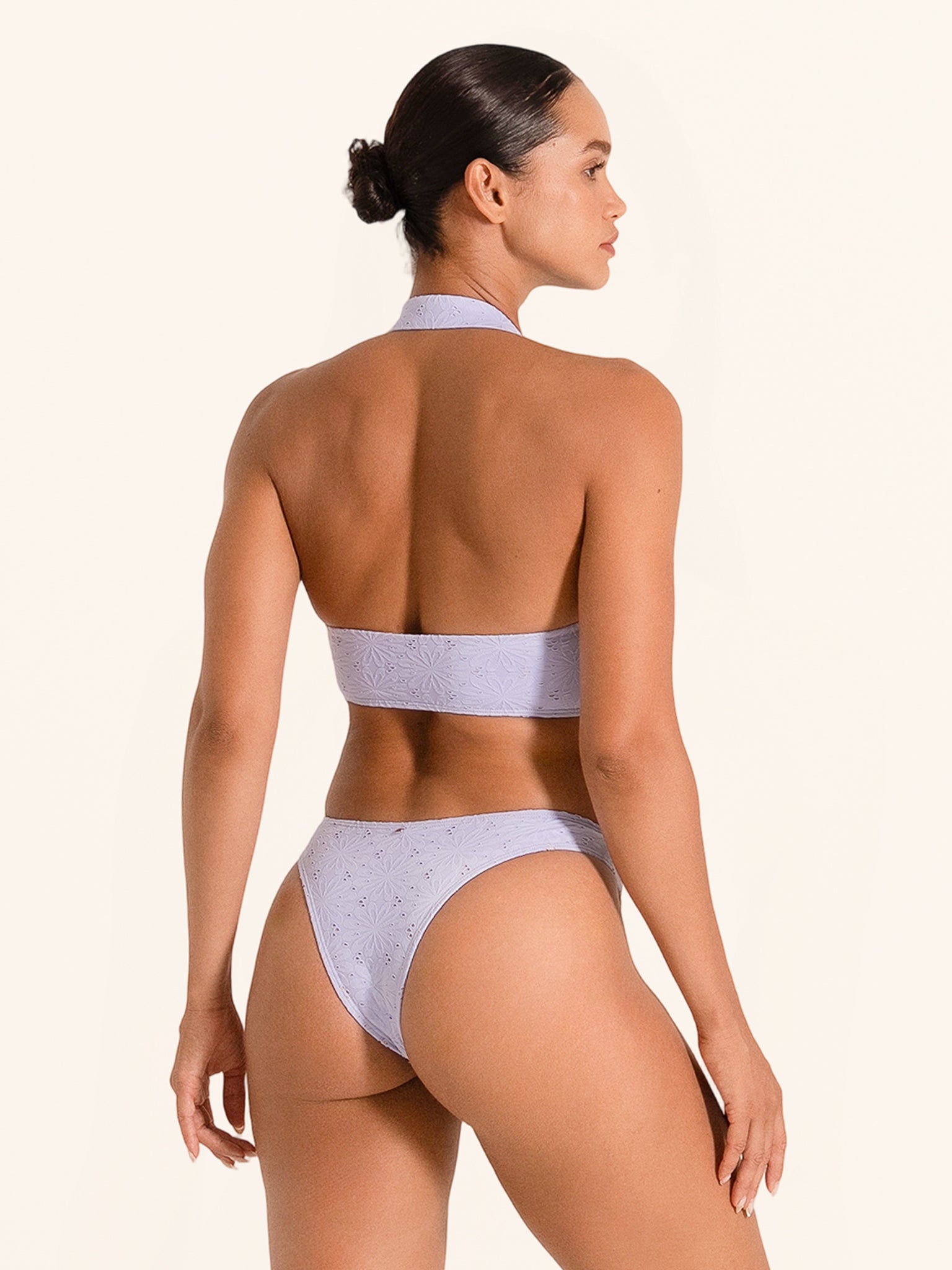 Lilac bikini top with high halter neckline and stylish cutout.