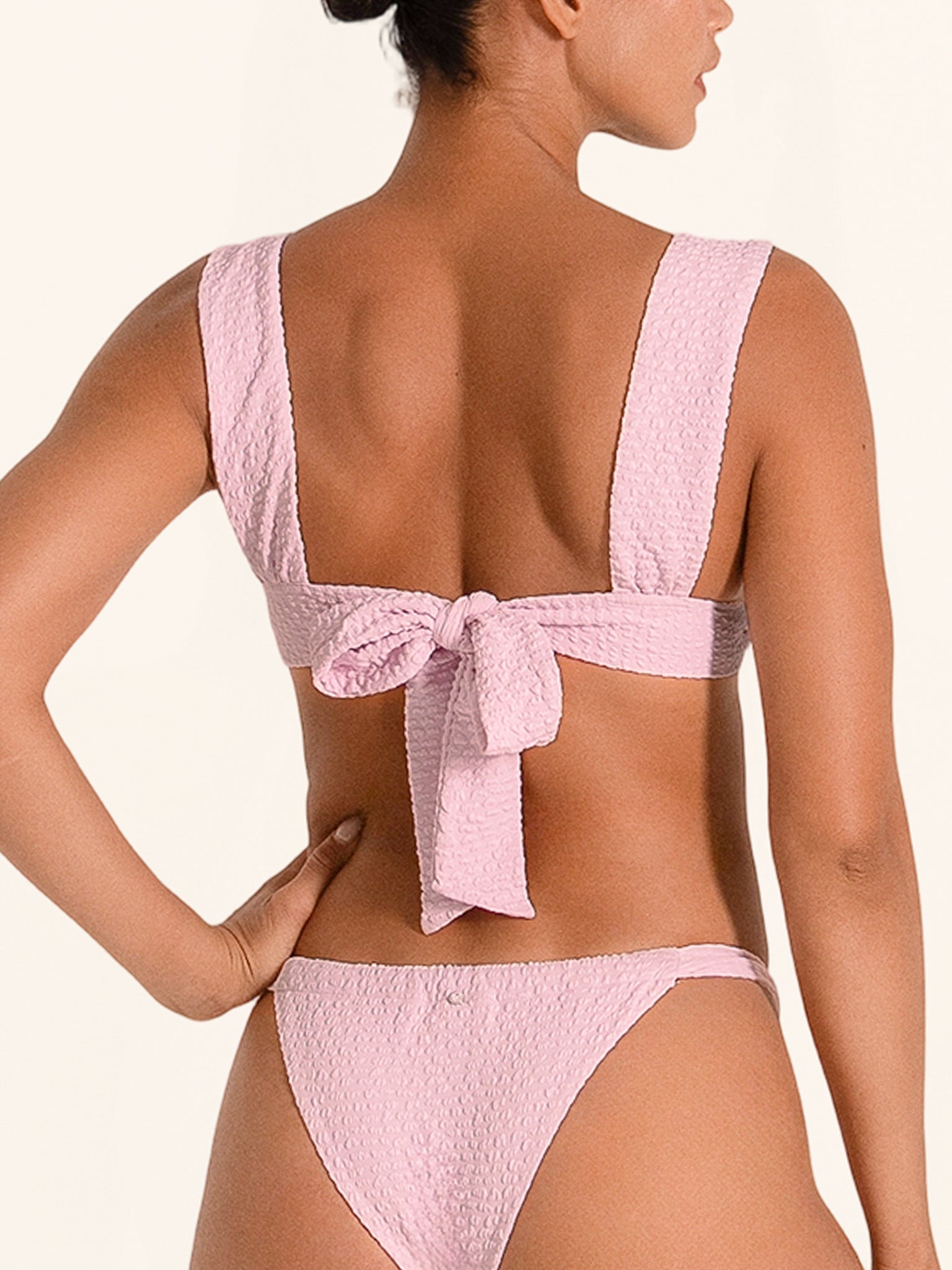 Lilac bikini top with wide straps, textured finish, and adjustable tie back.