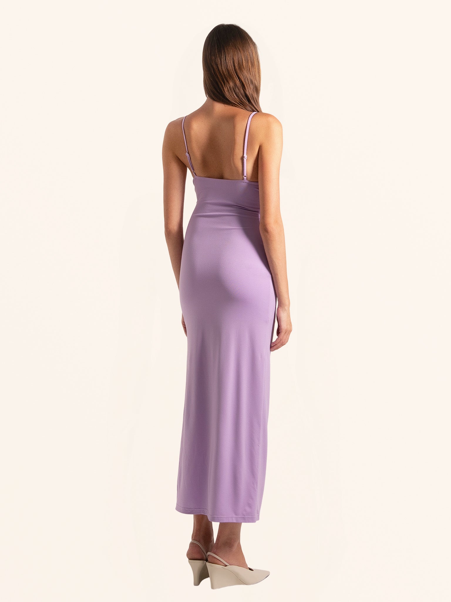 Rear side profile of lilac cut out maxi dress with spaghetti straps and sleek hem