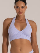 Close-up front view of lilac halter bikini top featuring floral broderie details