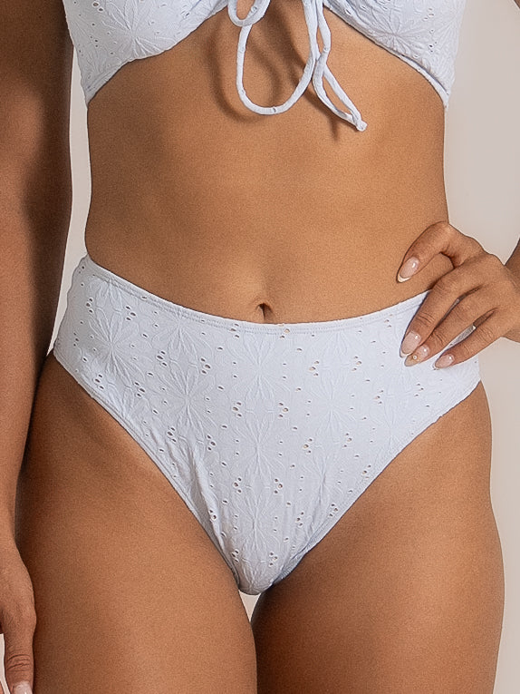 Close-up of lilac side-tie bikini bottom featuring ruched texture and high-leg cut