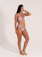 Lilac bikini set side view showcasing wide straps and cheeky cut