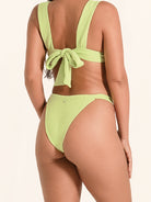 Lime green swim bottom featuring wide supportive sides and cheeky coverage.