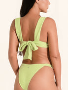 Deep V lime green swim top featuring wide straps and adjustable fit.