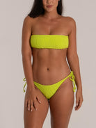 Front view of bandeau-style lime green bikini featuring textured fabric and side ties
