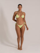 Woman wearing lime green textured triangle bikini set front view