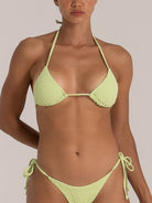 Close-up of a lime green textured triangle bikini with halter neck tie and side-tie bottoms.