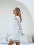 Elegant lined white lace dress: plunge neckline, hidden zipper, sparkling blue silver chest appliqué.